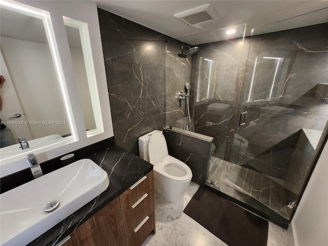 bathroom featuring a shower with door, vanity, and toilet