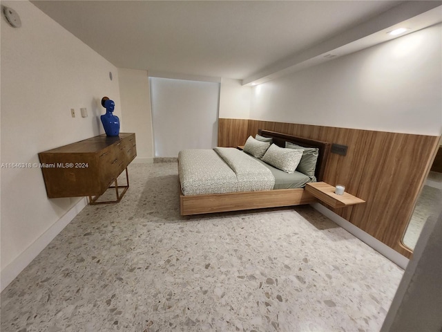 bedroom with wood walls and carpet flooring