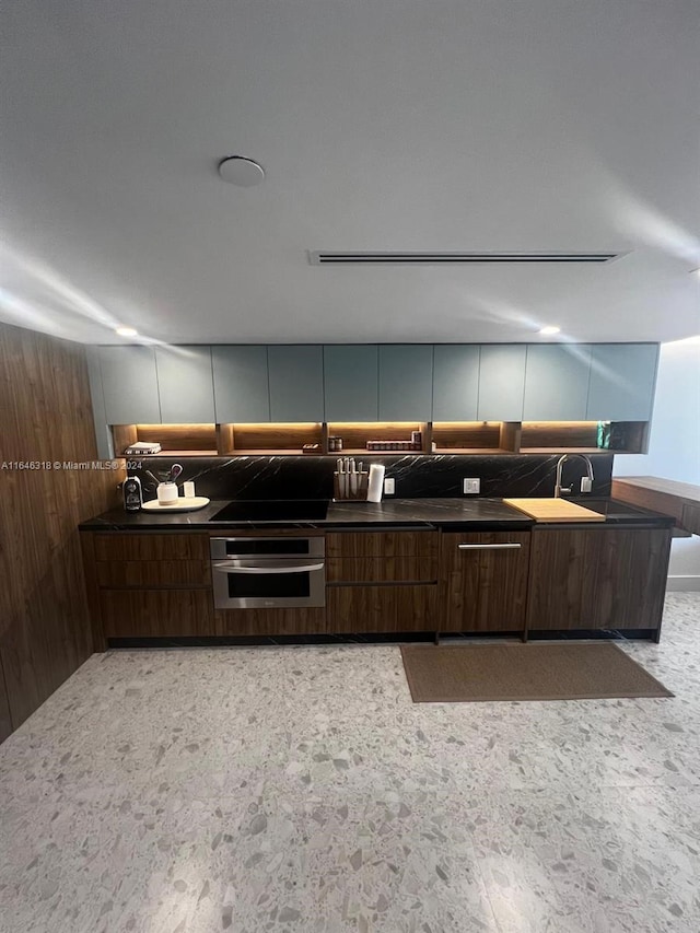 kitchen with dark brown cabinets and stainless steel oven