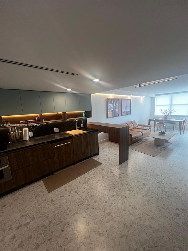 2555 Collins Ave Unit 306, Miami Beach, FL 33140 - kitchen featuring dark countertops, open floor plan, wall oven, and modern cabinets