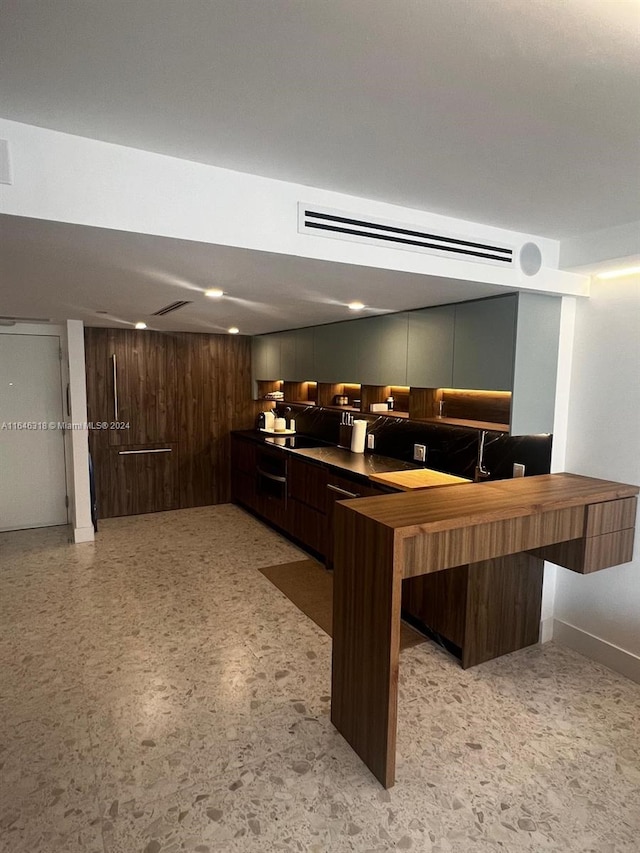 kitchen featuring dark brown cabinets and kitchen peninsula