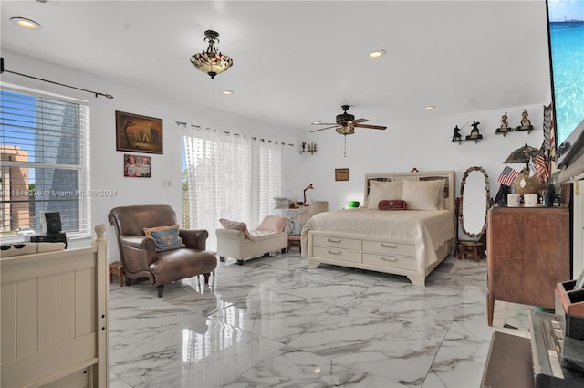 bedroom featuring multiple windows and ceiling fan