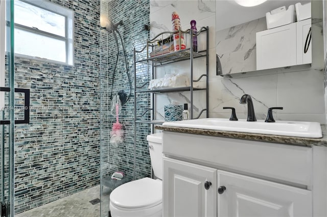 bathroom with vanity, an enclosed shower, backsplash, tile walls, and toilet