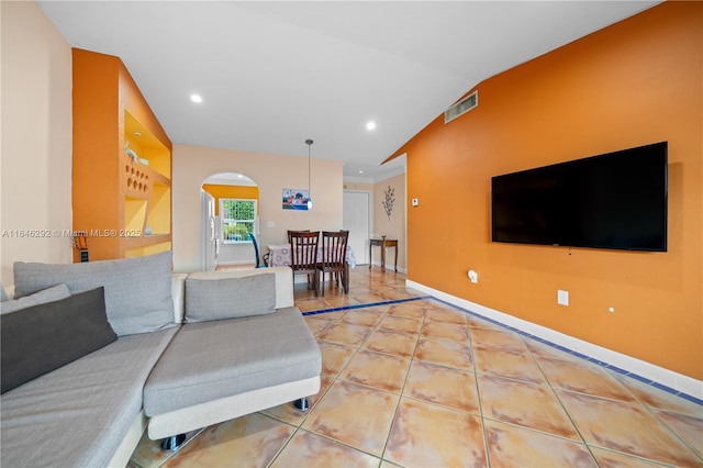 living room featuring tile patterned flooring and lofted ceiling