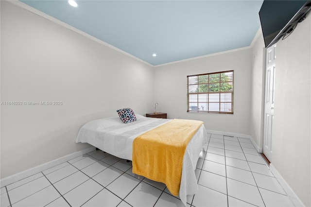 bedroom featuring ornamental molding, light tile patterned floors, and a closet