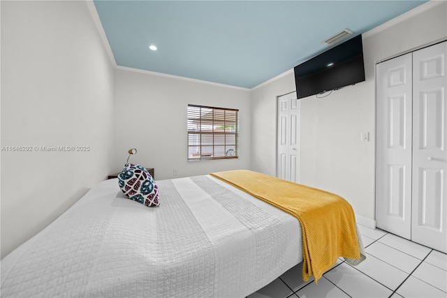 tiled bedroom featuring two closets and ornamental molding