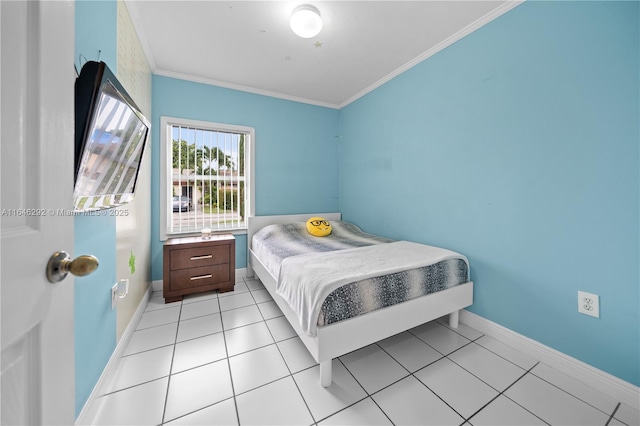 bedroom with ornamental molding and light tile patterned flooring