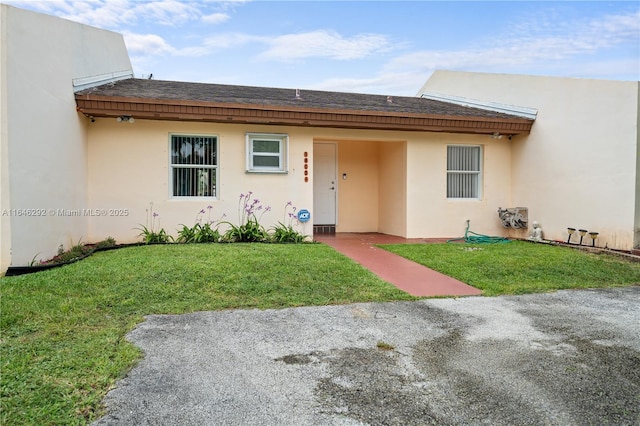 doorway to property featuring a lawn