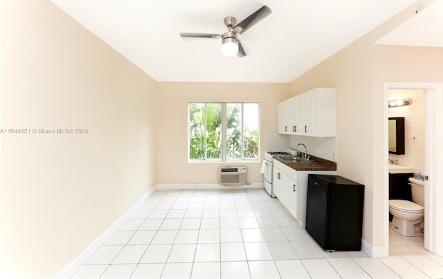 kitchen featuring white cabinets, sink, light tile patterned floors, and ceiling fan