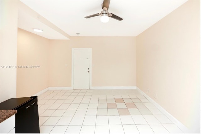 tiled spare room featuring ceiling fan