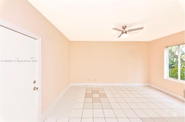 tiled empty room with ceiling fan