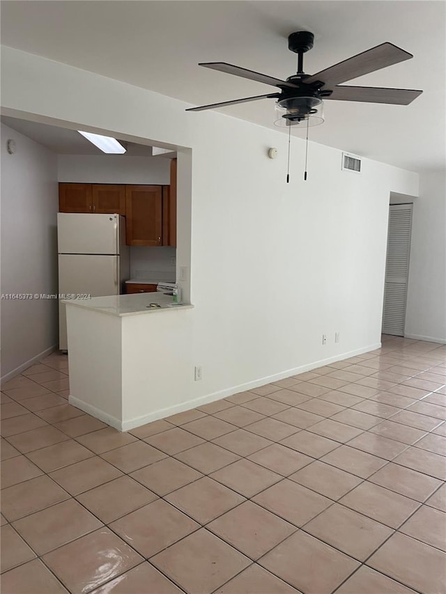 interior space with ceiling fan