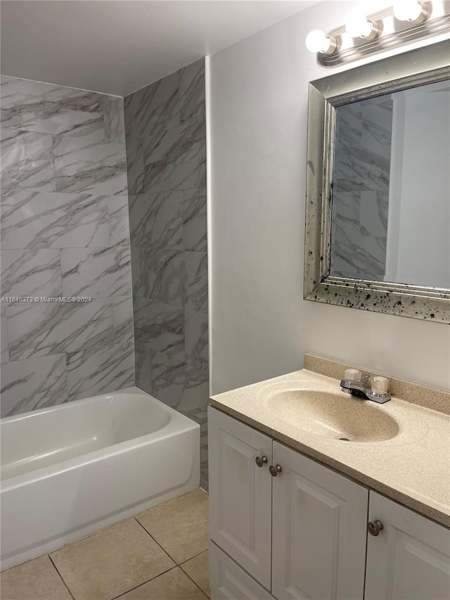 bathroom featuring tile patterned floors, vanity, and tiled shower / bath combo