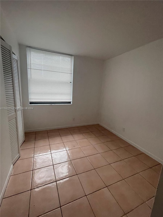 empty room with light tile patterned floors