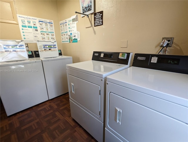 laundry area with separate washer and dryer and dark parquet floors