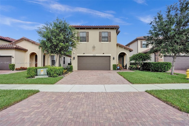 mediterranean / spanish house with a garage