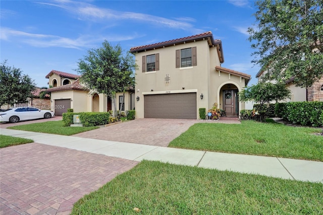 mediterranean / spanish-style house with a garage and a front lawn