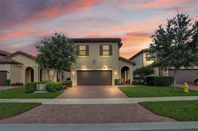 mediterranean / spanish-style house with a garage