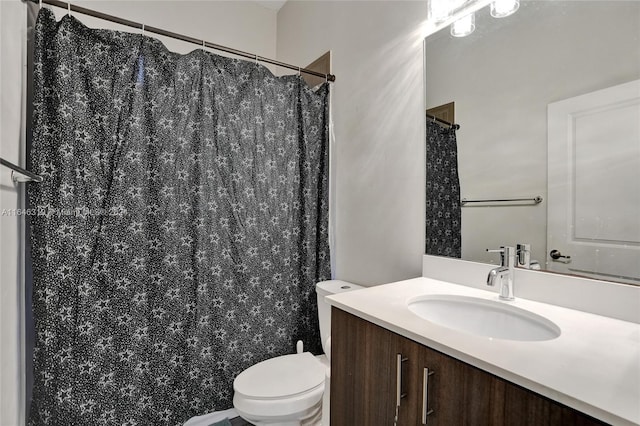 bathroom featuring a shower with curtain, toilet, and vanity