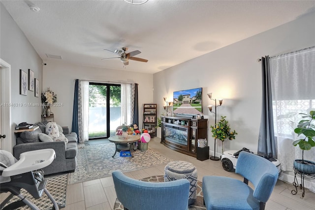 tiled living room featuring ceiling fan