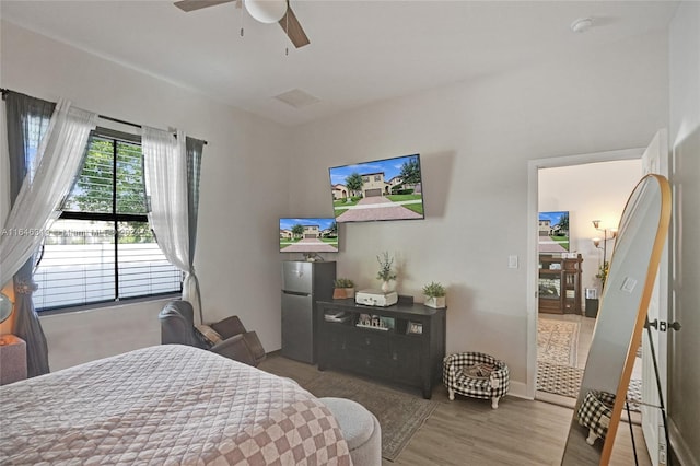 bedroom with hardwood / wood-style floors and ceiling fan