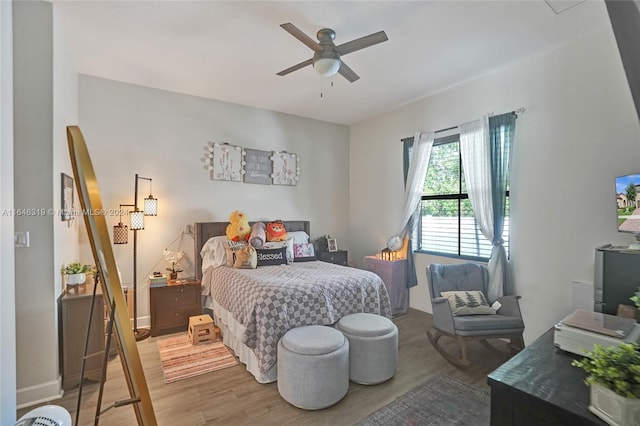 bedroom featuring dark wood-type flooring and ceiling fan