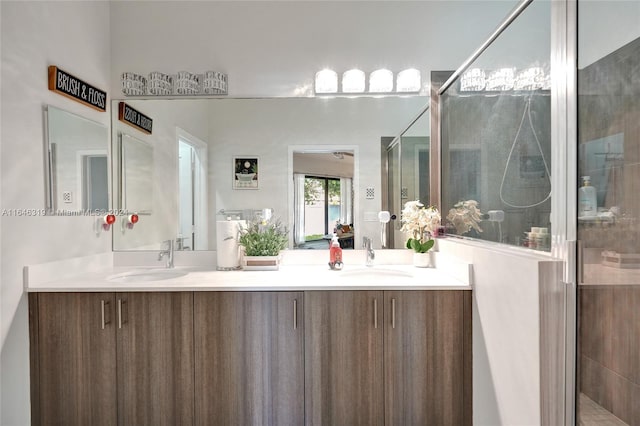 bathroom with vanity and a shower with door