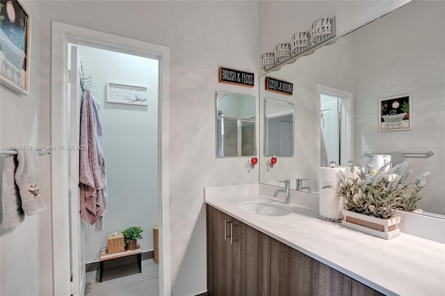 bathroom with vanity and a shower with shower door