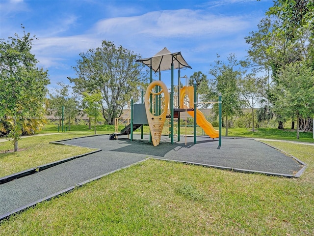 view of playground with a lawn