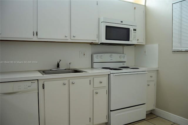 kitchen with sink, white appliances, white cabinetry, and light tile patterned floors