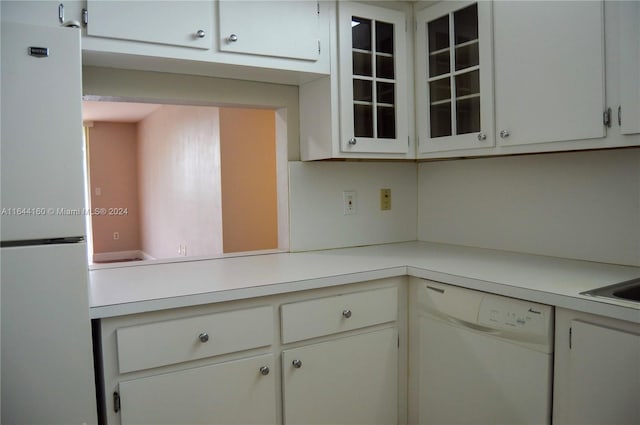 kitchen featuring white cabinetry and white appliances