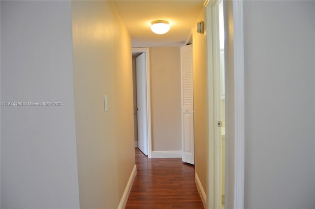 hallway with dark hardwood / wood-style floors