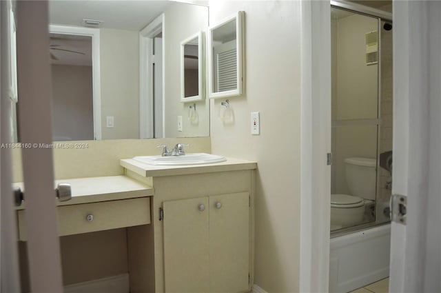 full bathroom featuring shower / bath combination with glass door, toilet, and vanity