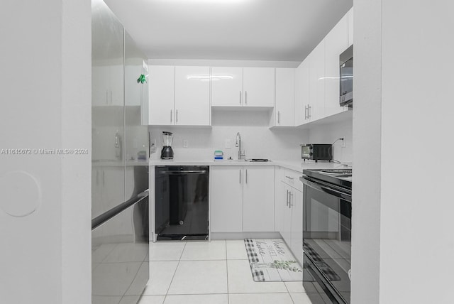 kitchen featuring backsplash, white cabinets, sink, black appliances, and light tile patterned flooring