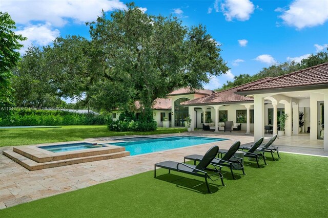 view of swimming pool with a lawn, an in ground hot tub, and a patio