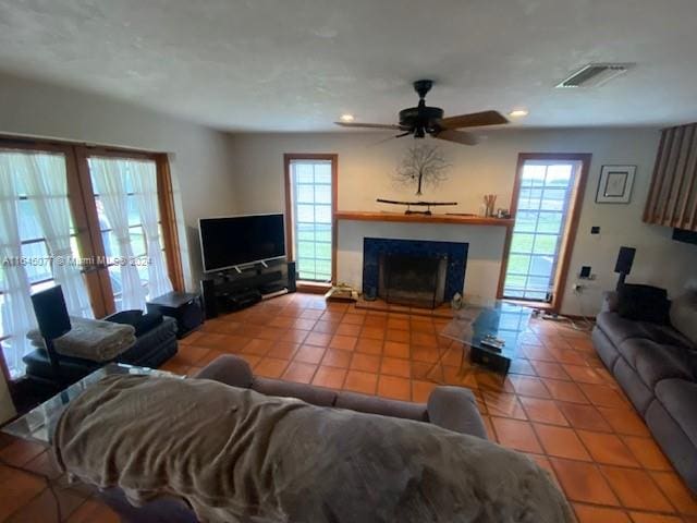 living room featuring ceiling fan and tile patterned floors