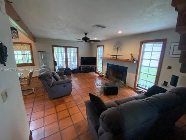 tiled living room with ceiling fan