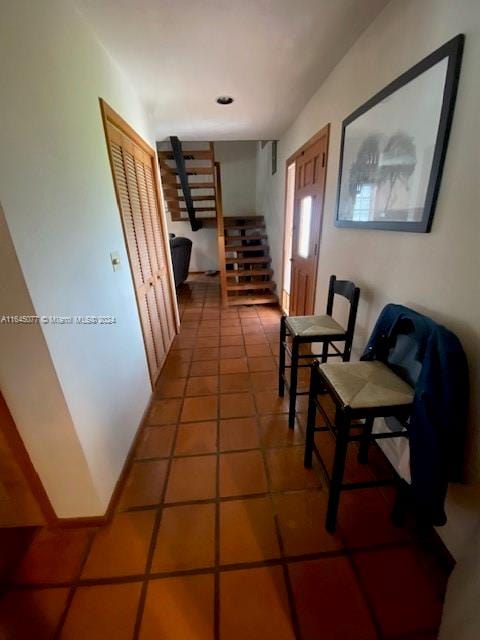 hallway with tile patterned floors