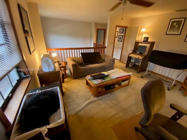 living room with ceiling fan and light carpet