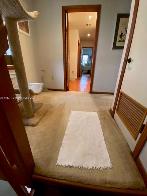 corridor with light tile patterned floors