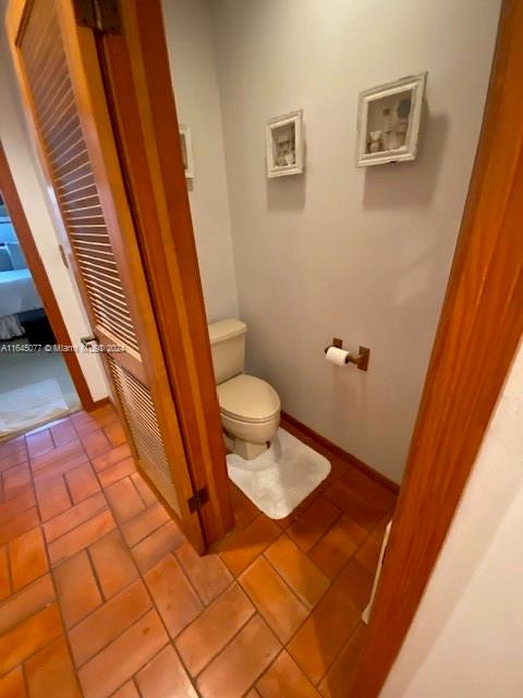 bathroom with toilet and tile patterned floors