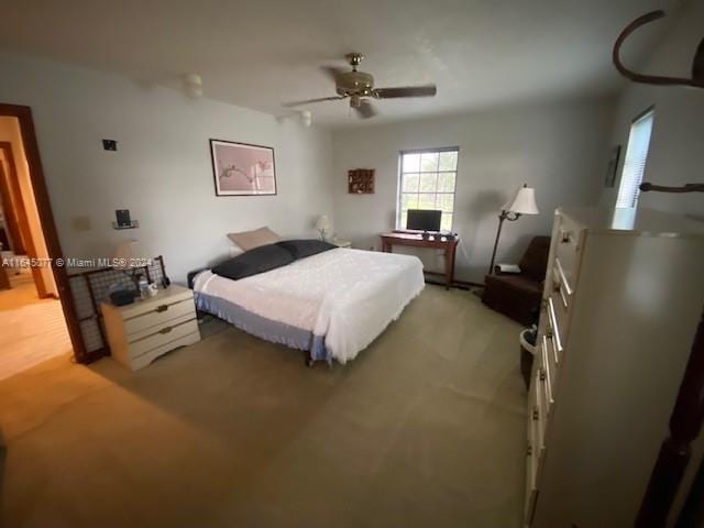 bedroom with ceiling fan and light carpet