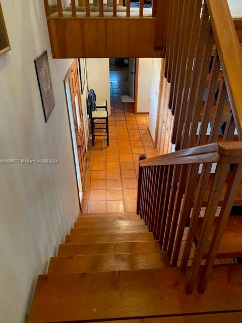 staircase featuring tile patterned floors