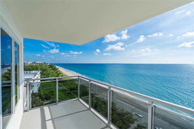 balcony with a view of the beach and a water view