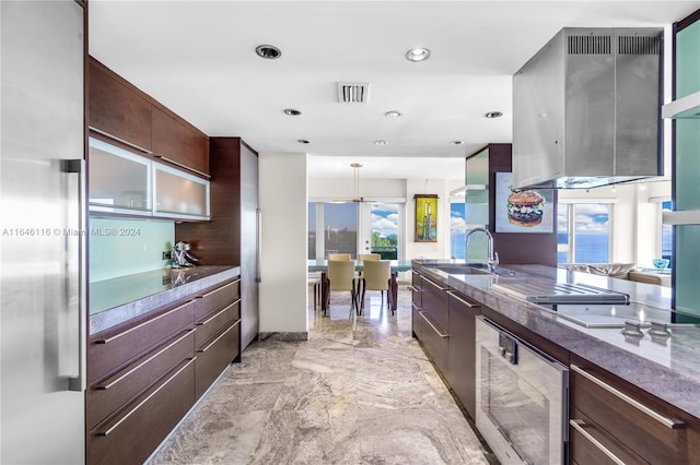 kitchen featuring visible vents, a sink, dark brown cabinets, and modern cabinets