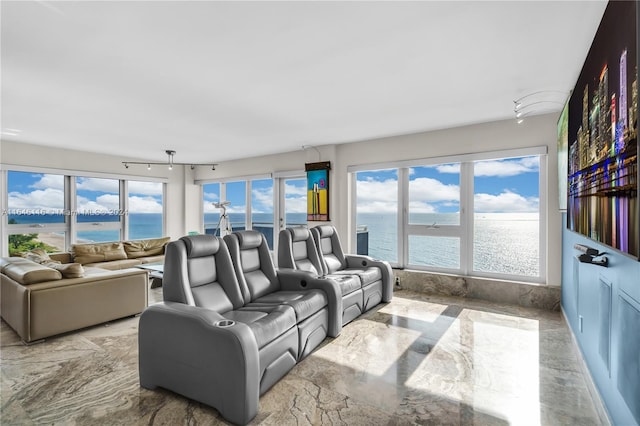 living area featuring marble finish floor and a water view