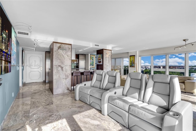 living area featuring marble finish floor and visible vents