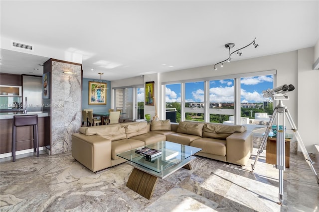 living area featuring marble finish floor and visible vents