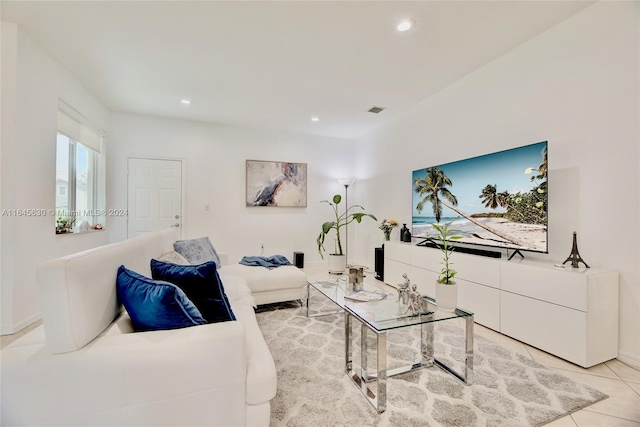 living room featuring light tile patterned floors, baseboards, visible vents, and recessed lighting