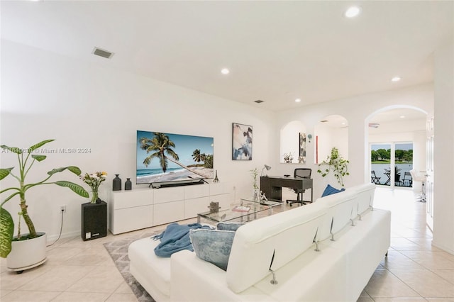 living area with light tile patterned floors, visible vents, and recessed lighting